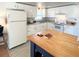 The kitchen includes white cabinets and an island perfect for food preparation at 415 Oakwood E Blvd, Sarasota, FL 34237