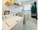 Bright laundry room with washer, dryer, and utility sink at 415 Oakwood E Blvd, Sarasota, FL 34237