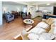 Open-concept living room with hardwood floors and views to the kitchen and dining area at 415 Oakwood E Blvd, Sarasota, FL 34237