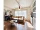 Bright living room featuring hardwood floors, built-in cabinets and large window at 415 Oakwood E Blvd, Sarasota, FL 34237