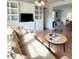 Bright living room featuring hardwood floors, built-in cabinets and views to the dining area at 415 Oakwood E Blvd, Sarasota, FL 34237