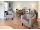 Bright living room featuring hardwood floors, chairs, and an adjacent dining area at 415 Oakwood E Blvd, Sarasota, FL 34237