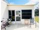 Cozy outdoor patio with a seating area and side entry at 415 Oakwood E Blvd, Sarasota, FL 34237