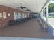 A covered outdoor seating area by the pool with ceiling fans and rocking chairs at 415 Oakwood E Blvd, Sarasota, FL 34237