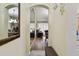 Bright hallway with wood floors, an arched doorway, a mirror, and views into the dining and living spaces at 4240 Bismarck Palm Dr, Tampa, FL 33610