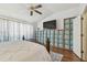 Bright and airy main bedroom with a ceiling fan and custom closet at 4240 Bismarck Palm Dr, Tampa, FL 33610