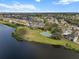 Aerial view of the community featuring a lake, tennis court, and well-manicured lawns at 4805 52Nd W Ave, Bradenton, FL 34210