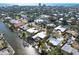 Expansive aerial view of waterfront homes with private docks and the city skyline in the distance at 5073 Higel Ave, Sarasota, FL 34242