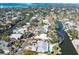 Aerial view of the neighborhood featuring a waterfront property with canal access and lush trees at 5073 Higel Ave, Sarasota, FL 34242