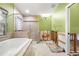 Bright bathroom features a soaking tub and walk-in glass shower at 5073 Higel Ave, Sarasota, FL 34242