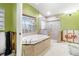 Bright bathroom features a soaking tub and walk-in glass shower at 5073 Higel Ave, Sarasota, FL 34242