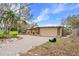Home exterior showing the driveway and damage from the hurricane at 5073 Higel Ave, Sarasota, FL 34242
