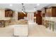 A view of the kitchen with a large island and custom cabinetry needing renovation at 5073 Higel Ave, Sarasota, FL 34242