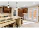 Kitchen space with a large island and custom cabinetry needing renovation and updates at 5073 Higel Ave, Sarasota, FL 34242