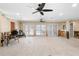 Bright, airy living room with tile floors, ceiling fan, and French doors leading to the pool at 5073 Higel Ave, Sarasota, FL 34242