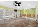 Expansive living room featuring hardwood floors and multiple glass doors at 5073 Higel Ave, Sarasota, FL 34242