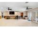 Spacious living room featuring tile floors, ceiling fans, and glass doors to outdoor area at 5073 Higel Ave, Sarasota, FL 34242