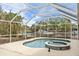 Beautiful in-ground pool and hot tub spa surrounded by a screened enclosure overlooking the canal at 5073 Higel Ave, Sarasota, FL 34242