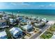 Aerial shot of a coastal home with a pool, surrounded by lush landscaping and waterfront access at 526 Loquat Dr, Anna Maria, FL 34216