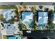 A birdseye view shows a beautiful home, pool, and tropical landscaping near the water at 526 Loquat Dr, Anna Maria, FL 34216