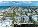 Lovely coastal home with pool and dock, surrounded by beautiful landscaping and waterfront access at 526 Loquat Dr, Anna Maria, FL 34216