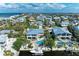 Expansive aerial view of a coastal community with waterfront homes, lush vegetation, and ocean views at 526 Loquat Dr, Anna Maria, FL 34216