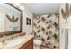 Bathroom featuring a vanity, commode, mirror, and shower with stylish tropical patterned curtain at 526 Loquat Dr, Anna Maria, FL 34216