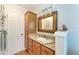 Bathroom with a granite countertop vanity, storage cabinets, and neutral-toned walls at 526 Loquat Dr, Anna Maria, FL 34216