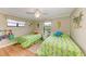 Cozy bedroom with two beds, ceiling fan, and nautical decor for a beachy vibe at 526 Loquat Dr, Anna Maria, FL 34216