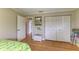 Bedroom featuring hardwood floors, closet, and decorative mirror enhancing the room's appeal at 526 Loquat Dr, Anna Maria, FL 34216