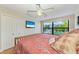Comfortable bedroom with large windows providing lush views, ceiling fan, and access to closet space at 526 Loquat Dr, Anna Maria, FL 34216
