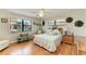 Airy bedroom with hardwood floors, a ceiling fan, and large windows offering natural light at 526 Loquat Dr, Anna Maria, FL 34216