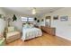 Bright and serene bedroom with hardwood floors, ceiling fan, and natural light through large windows at 526 Loquat Dr, Anna Maria, FL 34216