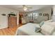 Cozy bedroom with wood floors, windows with a neighborhood view, and ample storage space at 526 Loquat Dr, Anna Maria, FL 34216