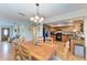 Open-concept dining area with wood table and chairs, flowing into the kitchen at 526 Loquat Dr, Anna Maria, FL 34216