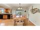 Dining area with wood table and chairs, open to the kitchen and patio at 526 Loquat Dr, Anna Maria, FL 34216