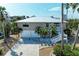 Charming two-story coastal home with a metal roof, garage, and beautifully landscaped yard at 526 Loquat Dr, Anna Maria, FL 34216