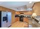 Well-equipped kitchen featuring stainless steel appliances and wooden cabinets at 526 Loquat Dr, Anna Maria, FL 34216