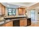 Close-up of the kitchen featuring wooden cabinets and black appliances at 526 Loquat Dr, Anna Maria, FL 34216