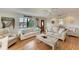 Bright living room with large window, nautical decor, and comfortable couches at 526 Loquat Dr, Anna Maria, FL 34216