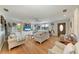 Spacious living room with hardwood floors, large television, and beach-themed decorations at 526 Loquat Dr, Anna Maria, FL 34216