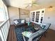 Relaxing patio with comfortable seating, ceiling fan, and lovely tropical views at 526 Loquat Dr, Anna Maria, FL 34216