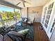 Inviting patio featuring comfortable seating, ceiling fan, and views of the tropical surroundings at 526 Loquat Dr, Anna Maria, FL 34216