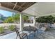 Relaxing porch with comfortable seating, offering a tranquil outdoor space with a view of the yard at 526 Loquat Dr, Anna Maria, FL 34216