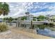 Waterfront property featuring a boat lift, dock, and stunning views at 526 Loquat Dr, Anna Maria, FL 34216