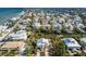 Aerial view of coastal neighborhood featuring homes, canals, and waterfront views at 527 Magnolia Ave, Anna Maria, FL 34216