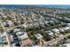 Broad aerial view displaying a vibrant neighborhood with canal access and quick access to beach and open water at 527 Magnolia Ave, Anna Maria, FL 34216