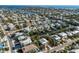 Scenic aerial shot highlights a waterfront community with homes with private boat docks, easy street access, and water views at 527 Magnolia Ave, Anna Maria, FL 34216