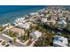 Beautiful aerial view showcases beachfront homes and calm ocean waters, surrounded by lush tropical landscaping at 527 Magnolia Ave, Anna Maria, FL 34216
