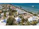 Picturesque aerial view of beachside homes with private pools, located near a sandy beach and boat dock at 527 Magnolia Ave, Anna Maria, FL 34216